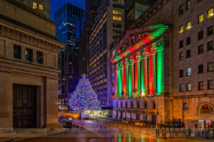 New York City Stock Exchange Wall Street NYSE Xmas - Wall Street in the Financial District in lower Manhattan in NYC with its 93rd annual Christmas tree. The facade is illuminated in the traditional Christmas  colors of red and green. 

This image is also available in black and white.

To view additional photographs please visit http://susancandelario.com